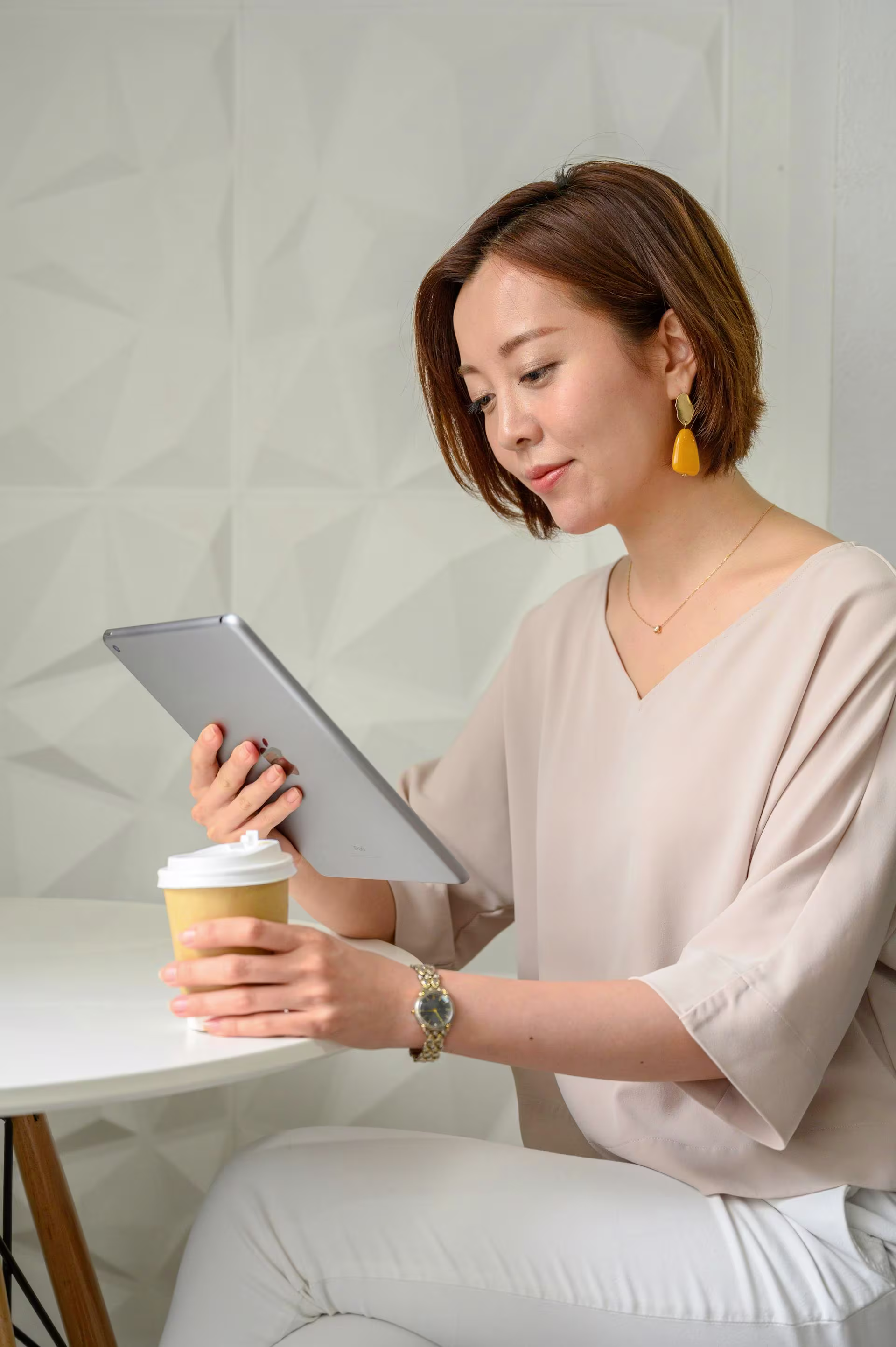A man wearing a beanie and glasses presenting a colorful visual content chart to a colleague across a desk in an office.